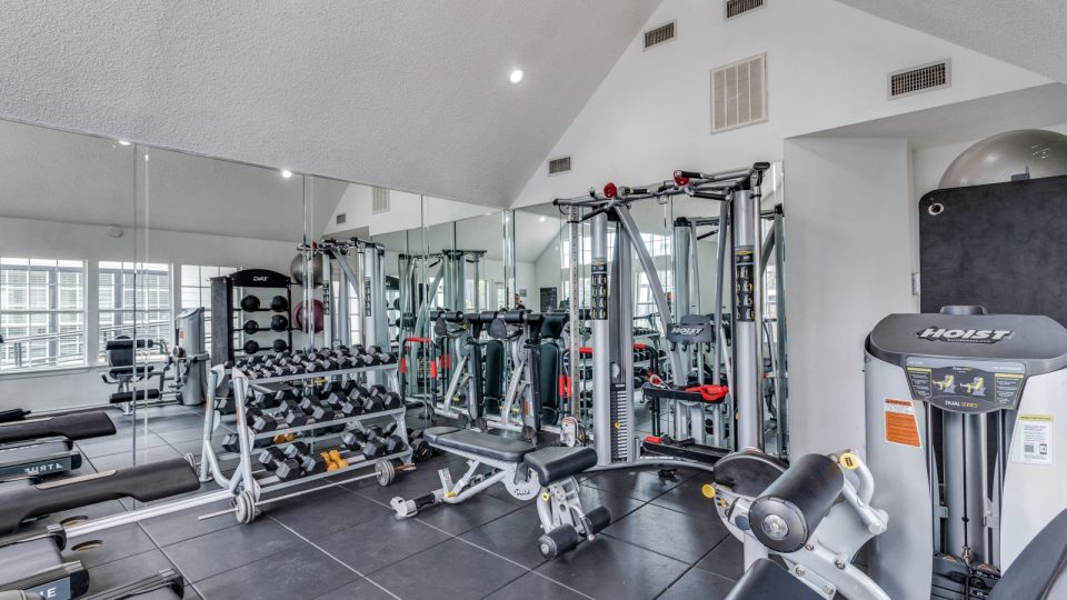 a gym room with a variety of equipment at The Westley