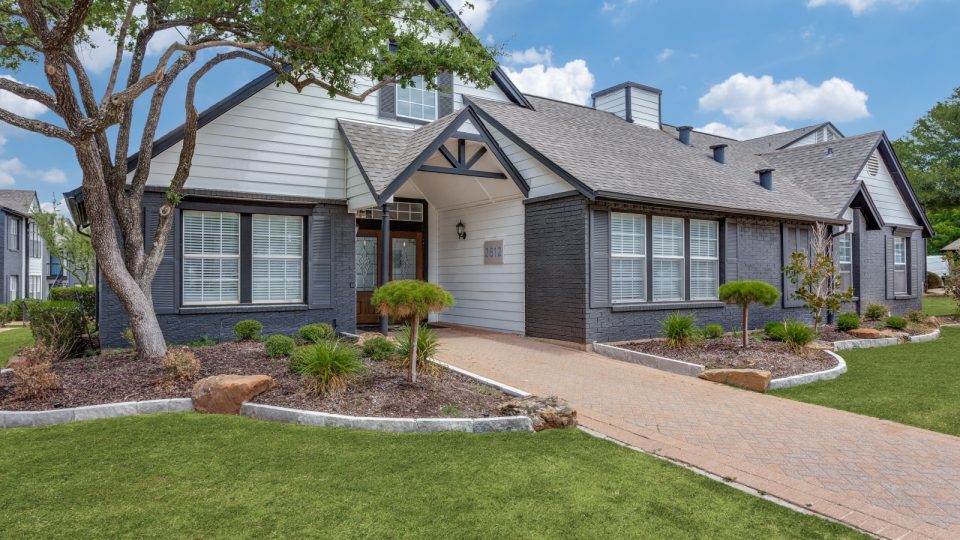 the front of a home with landscaping and a driveway at The Westley