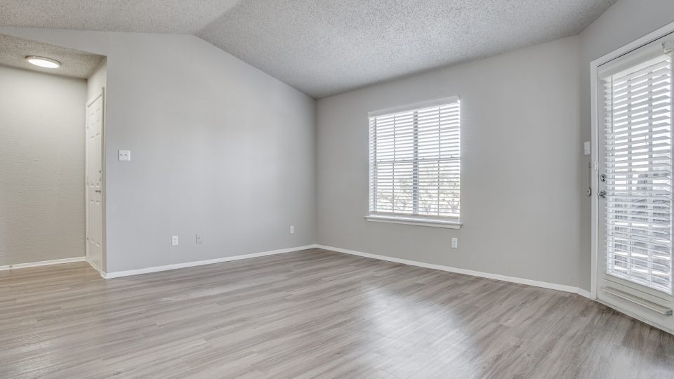empty room with hardwood floors and sliding glass doors at The Westley