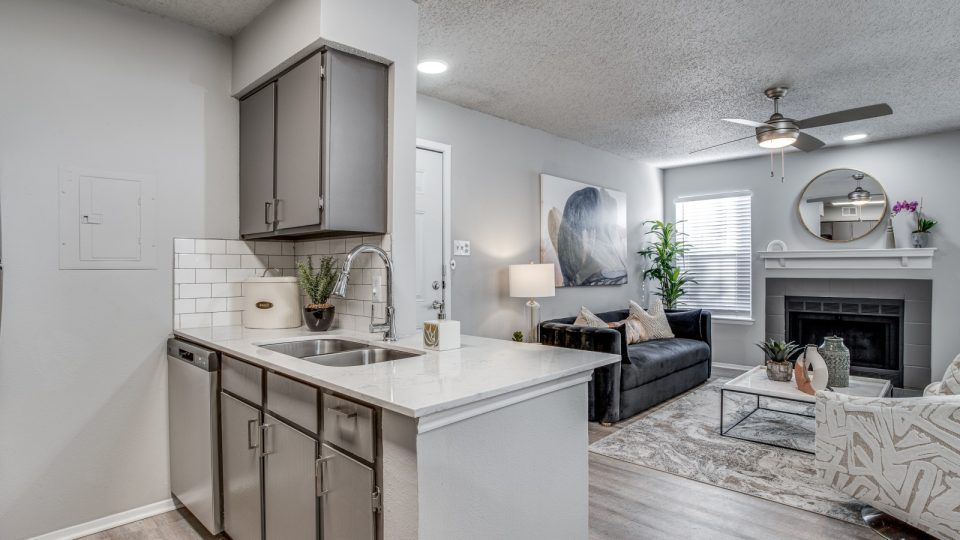 the kitchen and living room of a home with a fireplace at The Westley