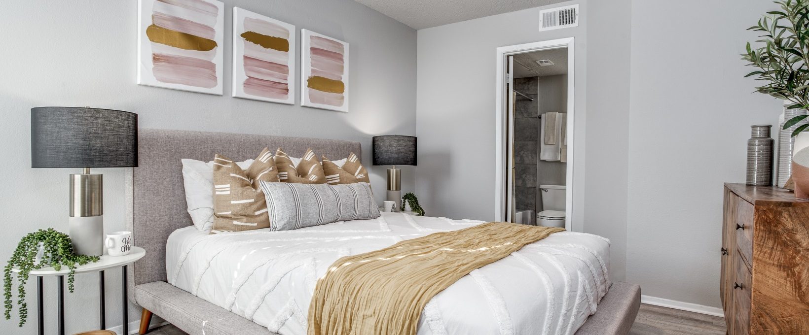 a bedroom with a bed, dresser, and nightstand at The Westley