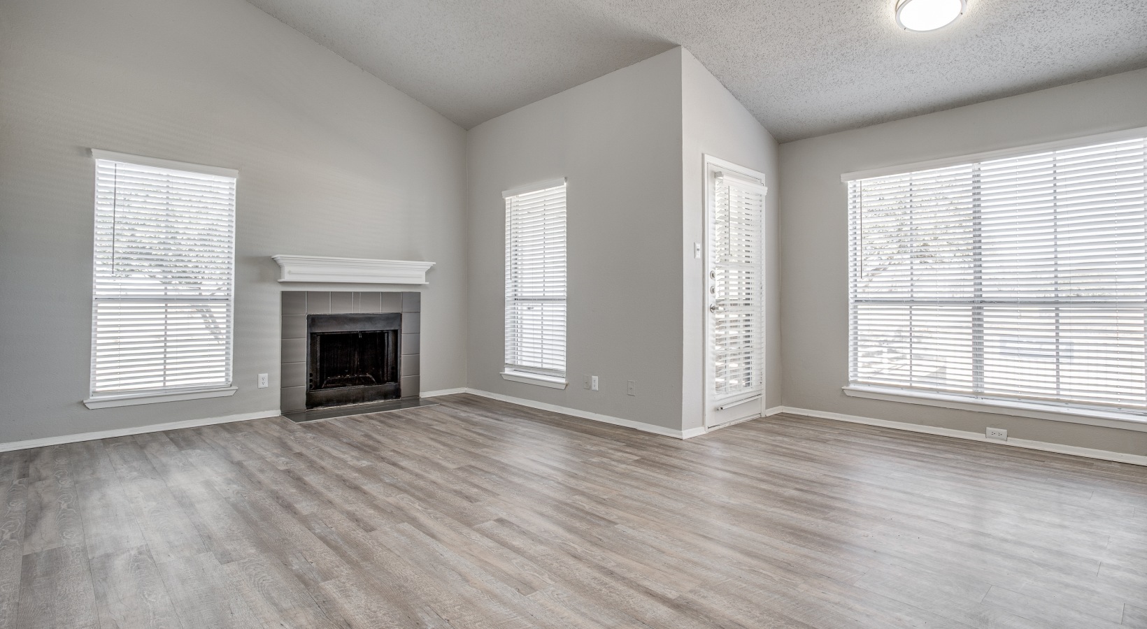 empty living room with hardwood floors and fireplace at The Westley