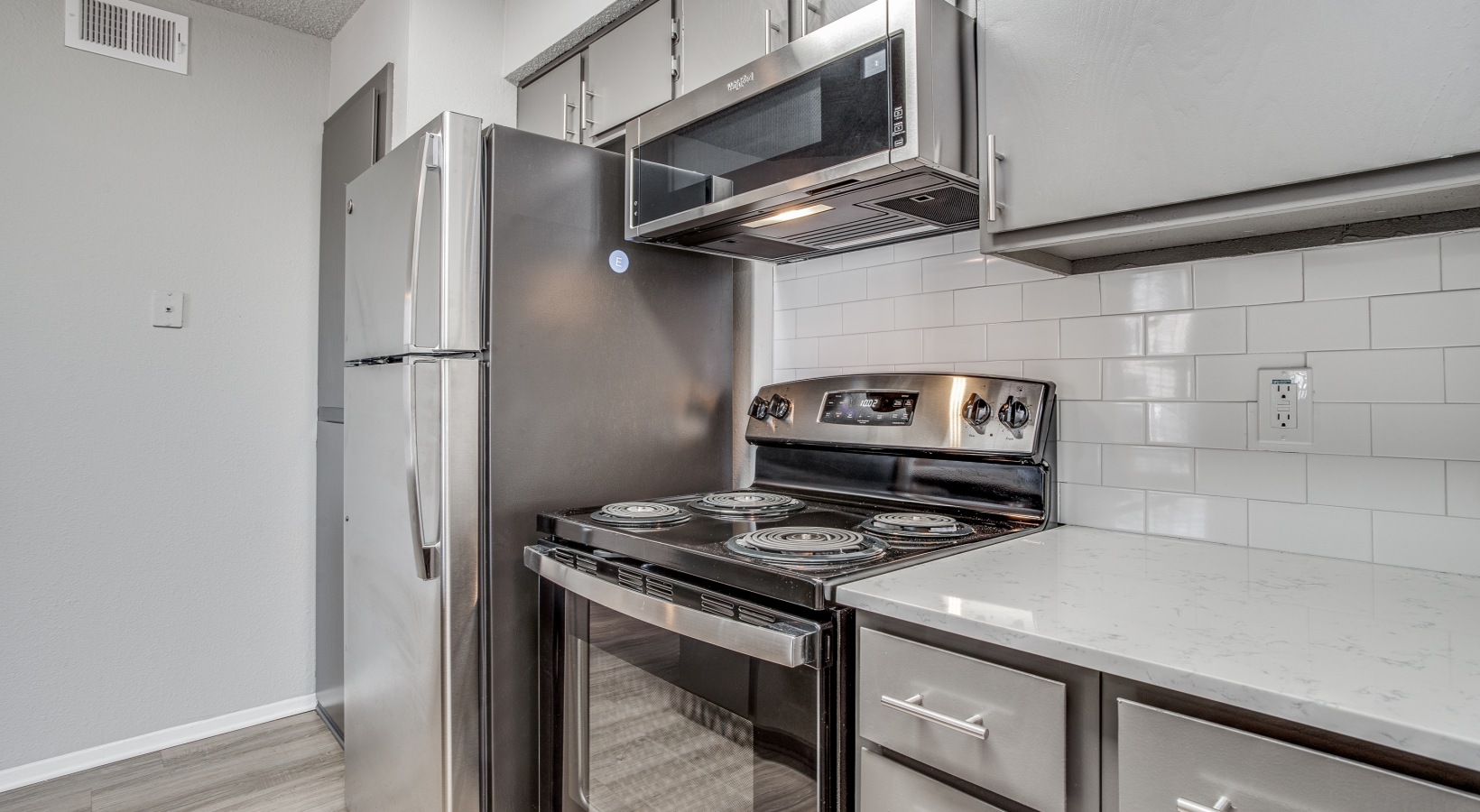 a kitchen with stainless steel appliances and a microwave at The Westley