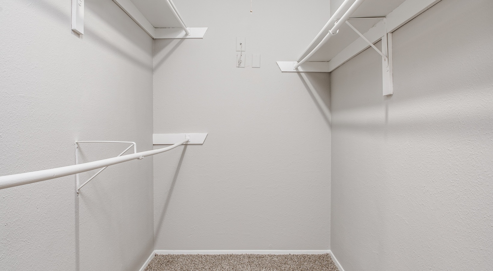 a walk in closet with shelves and a door at The Westley